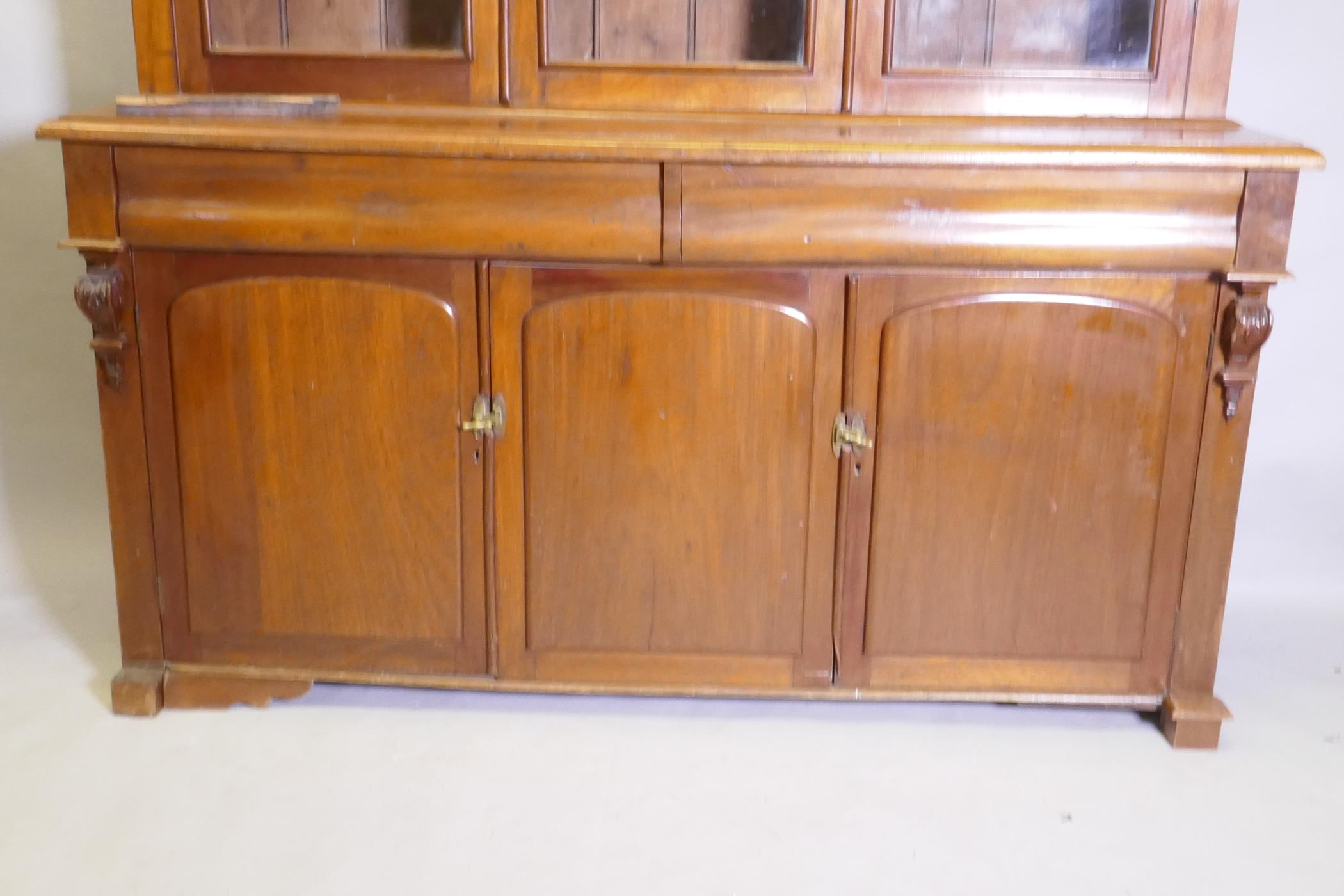 A C19th French stained fruitwood and walnut bookcase, the upper section with two glazed doors, - Image 2 of 4