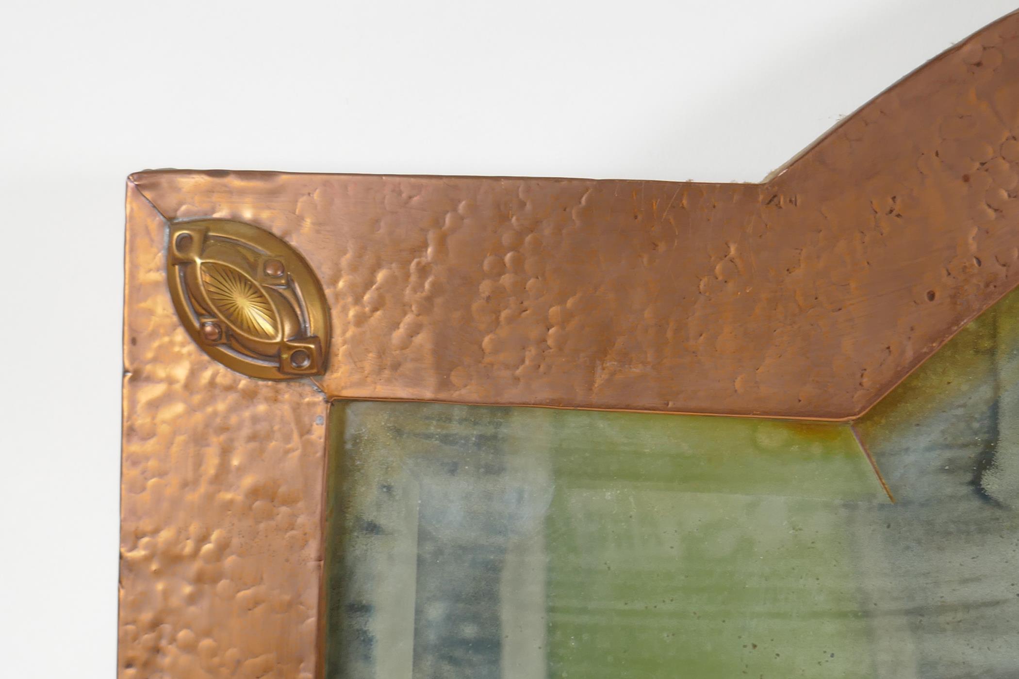 An Arts & Crafts hammered copper framed wall mirror with bevelled glass, the manner of Liberty of - Image 2 of 3