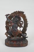 A Tibetan bronze figure of a wrathful deity, with the remnants of gilt patina, 24cm high