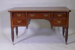 A Victorian mahogany kneehole desk, the five drawers with moulded fronts and brass handles, raised