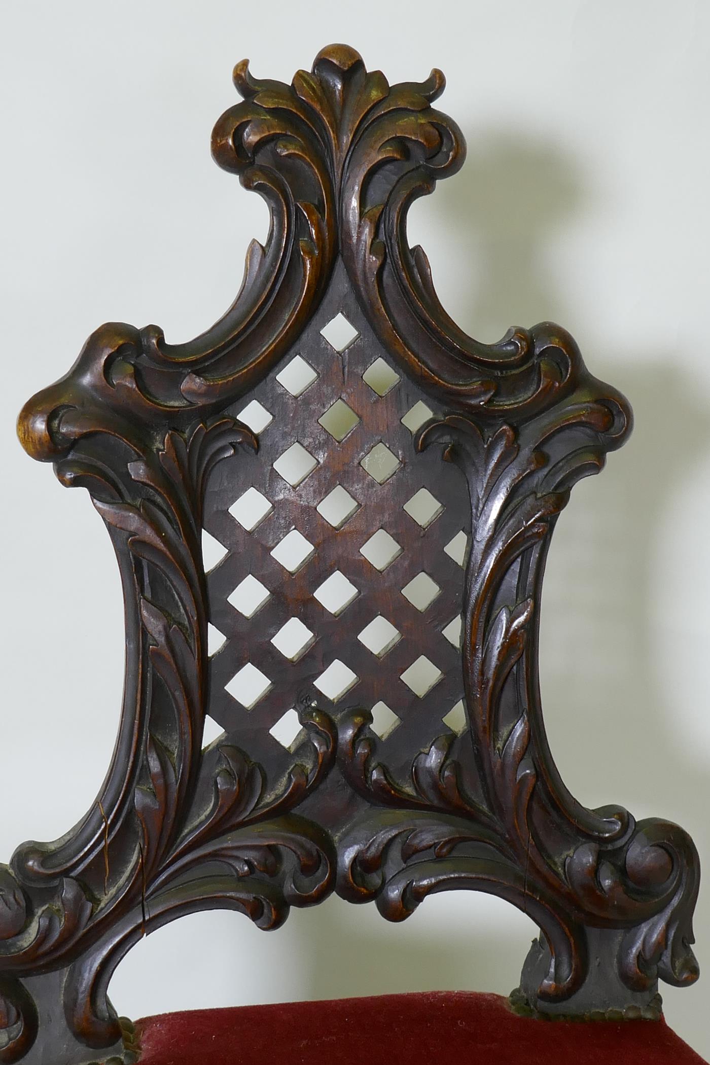 A C19th Chippendale style walnut hall chair, with carved and pierced trellis back, raised on - Image 3 of 3