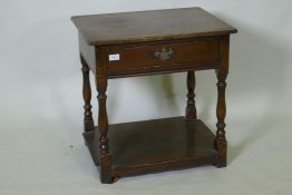 Antique style oak two tier single drawer side table, raised on baluster shaped supports, 48 x 60 x