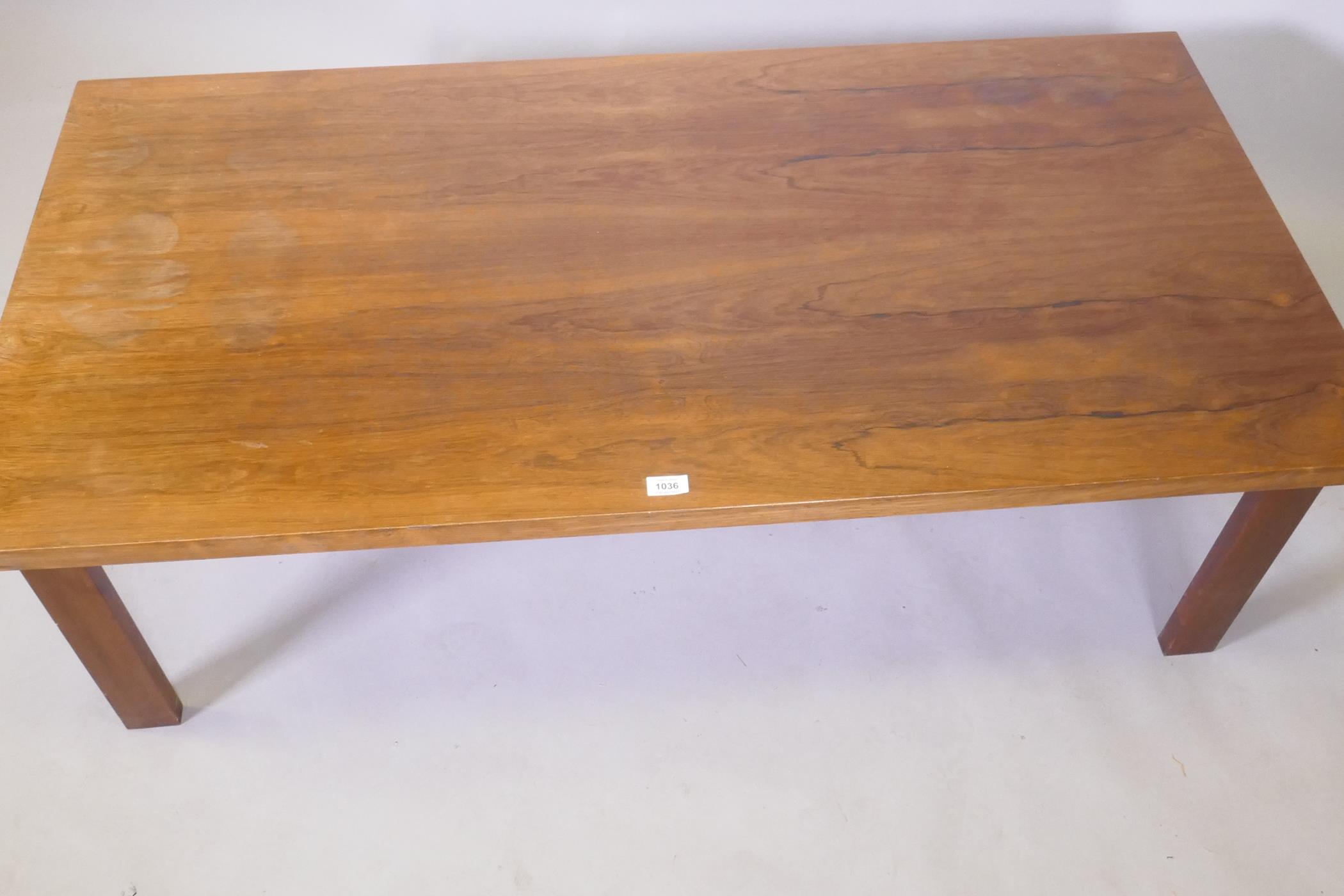 A mid century rosewood coffee table raised on square supports, 70 x 138 x 45cm - Image 2 of 4