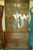 A Regency mahogany secretaire bookcase/estate cabinet, the upper section with two astragal glazed