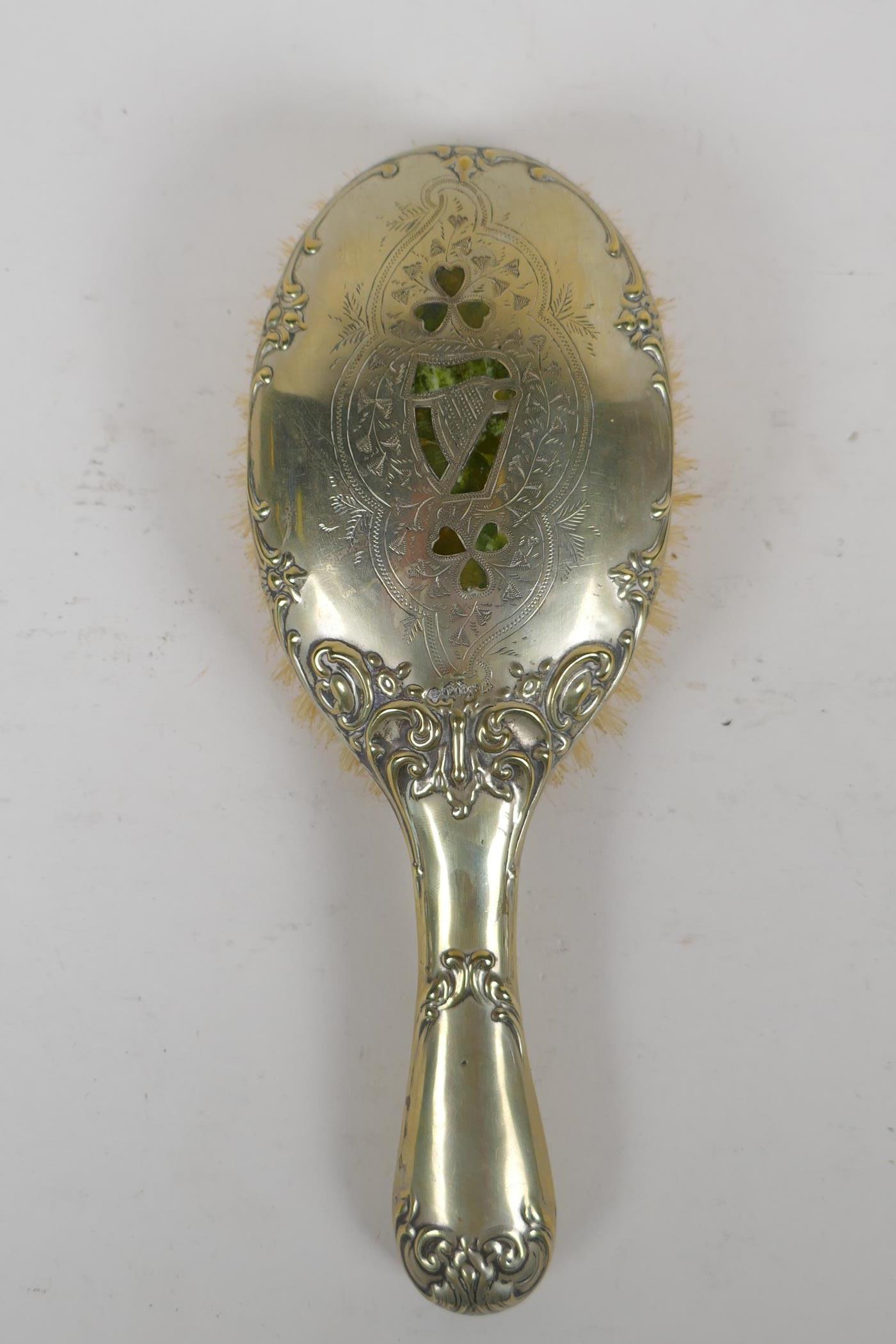 An antique Irish silver plated clothes brush, decorated with inlaid moss agate in the form of clover