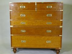 A fine late C19th/early C20th golden oak secretaire campaign style chest of two sections, the