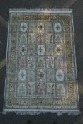 An ivory ground silk Kashan rug with panelled garden design, signed, 126 x 184cm