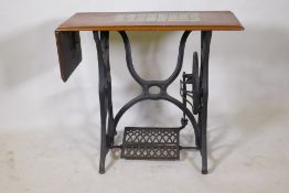A Victorian cast iron sewing machine table, with later tiled top, 86 x 41 x 74cm