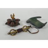 An Indian bronze six section tikka pot, a filled bronze Buddha's hand, and a Tibetan bronze vajra,