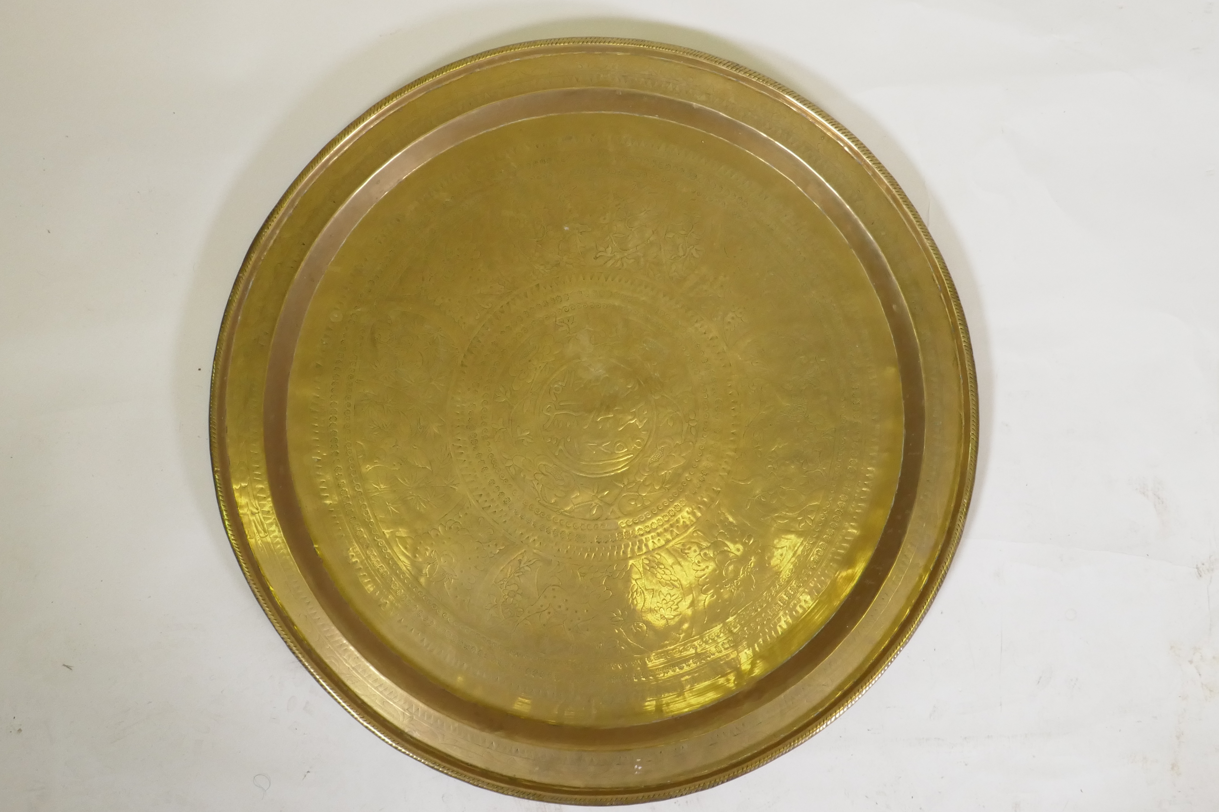 An Islamic brass tray with script decoration, together with another larger decorated with Islamic - Image 5 of 9