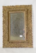 An antique Indian carved and gilt mirror with pierced details, 47 x 68cm