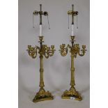 A pair of ormolu five branch candelabra table lamps with twisted columns and scroll supports, 84cm
