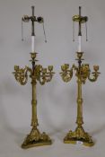 A pair of ormolu five branch candelabra table lamps with twisted columns and scroll supports, 84cm