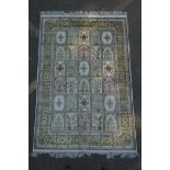 An ivory ground silk Kashan rug with panelled garden design, signed, 126 x 184cm