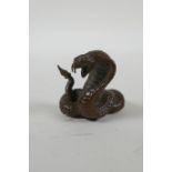 A Japanese style bronze okimono cobra, 4cm high