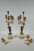 A pair of ormolu and bronze Regency style five branch candlesticks in the form of putti, 44cm
