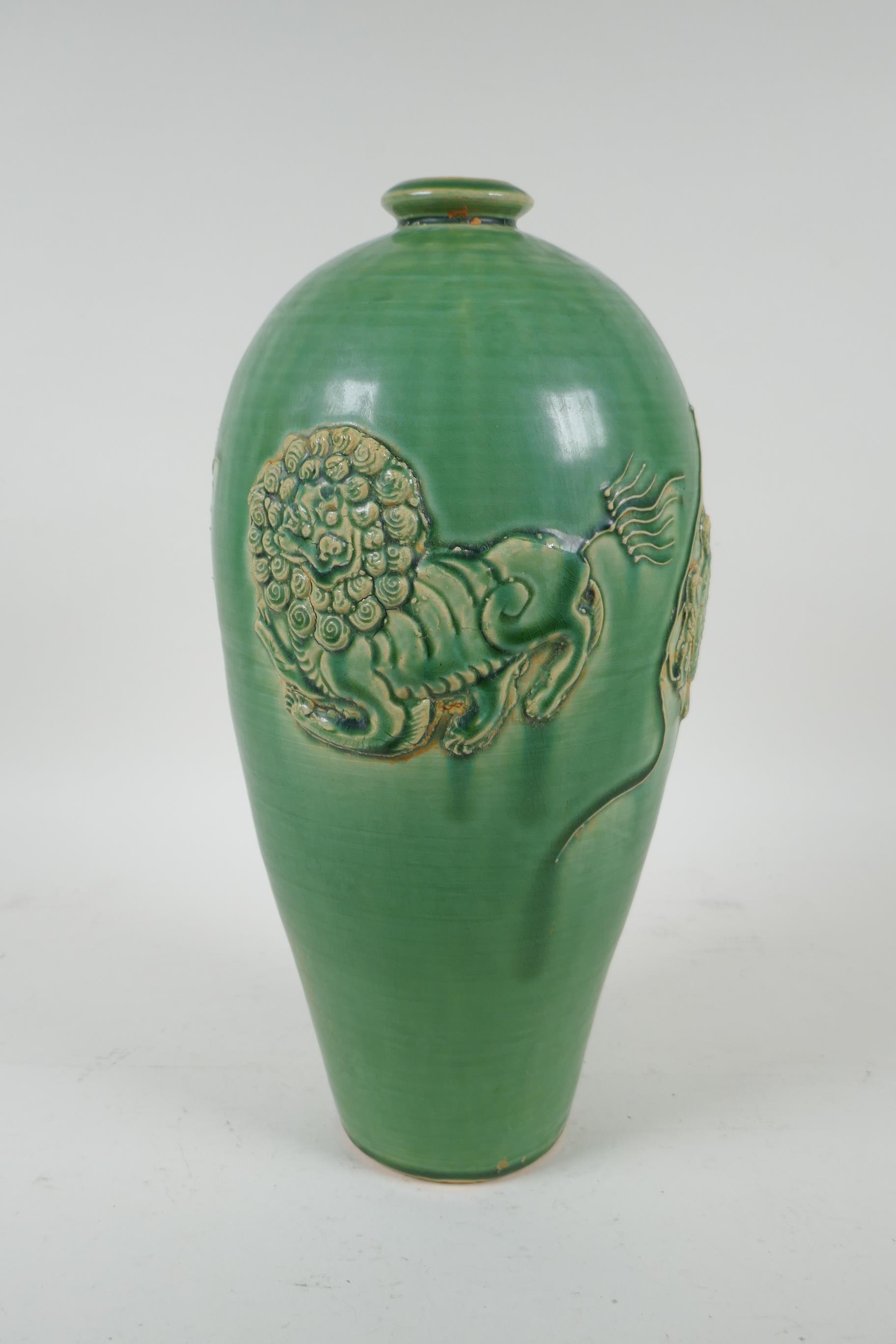 A Chinese celadon glazed porcelain vase with raised kylin decoration, 31cm high