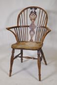 A C19th yew wood hoop back elbow chair with pierced splat and elm seat, back legs and stretchers, AF