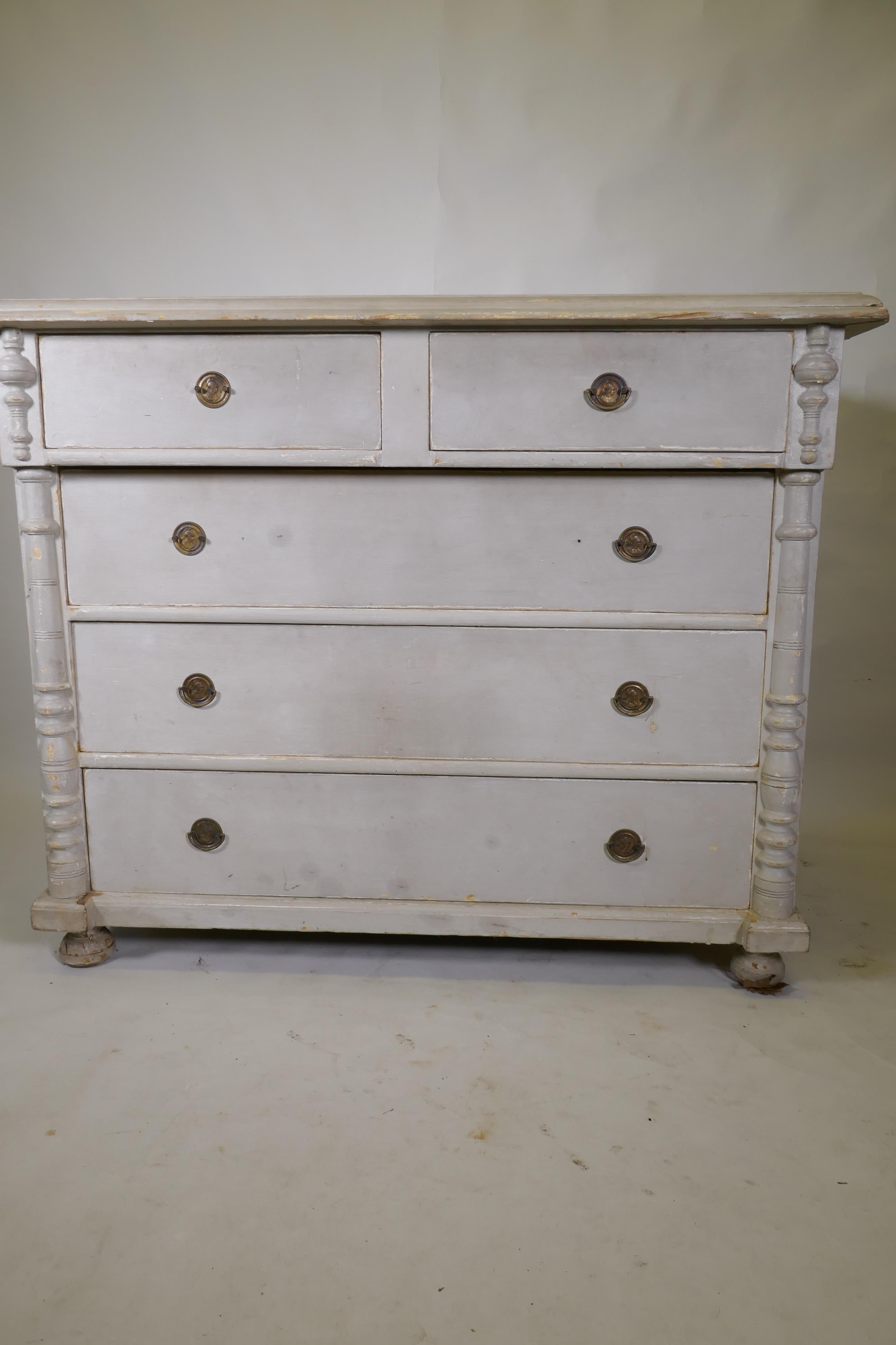 A C19th continental pine commode of two over three drawers flanked by column mouldings, raised on