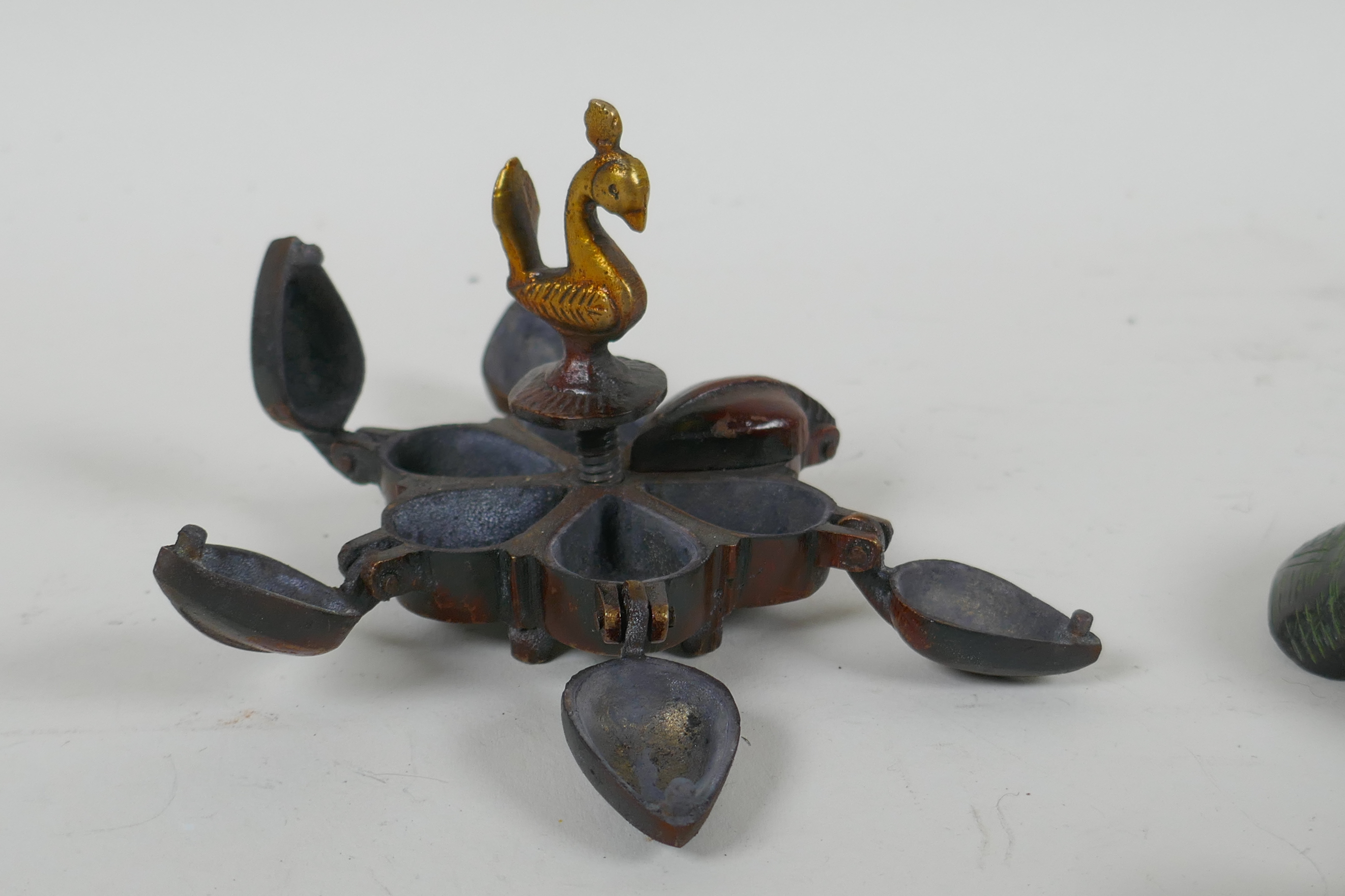 An Indian bronze six section tikka pot, a filled bronze Buddha's hand, and a Tibetan bronze vajra, - Image 3 of 5