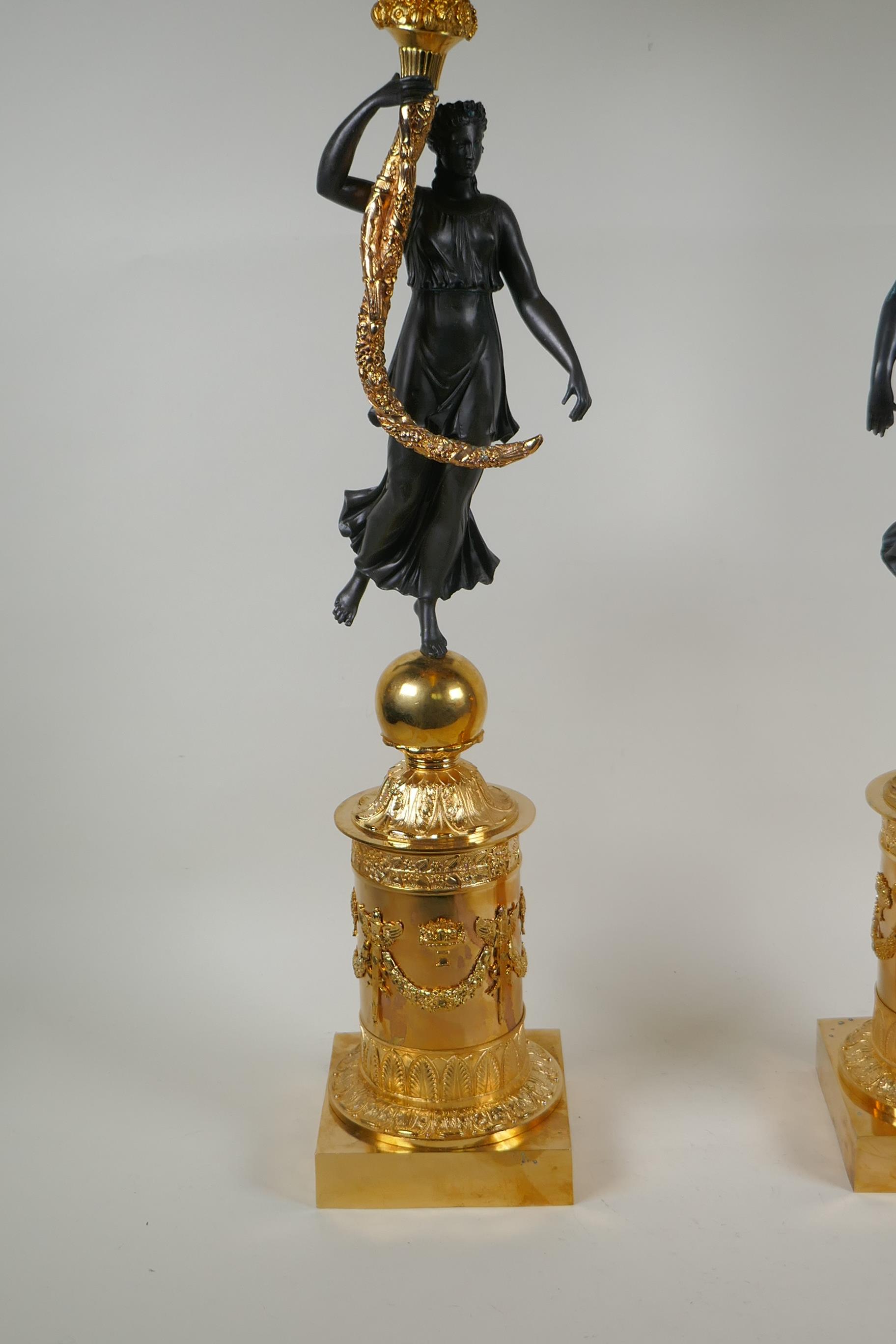 A pair of Regency style bronze and ormolu four branch candelabra in the form of classical women - Image 2 of 6