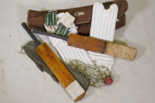 A collection of vintage cricket equipment to include two Keith Miller autograph bats, a set of pads,