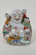 A Chinese polychrome porcelain figure group of a jolly Buddha and children, impressed seal mark to