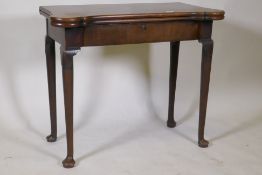 A Georgian mahogany fold over tea table with inlaid games top, shaped top and frieze drawer,