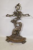 A Victorian style cast iron stick stand in the form of a seated dog with the legend Cave Canem, 75cm