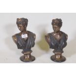 A pair of patinated bronze busts of women in classical attire, 29cm high