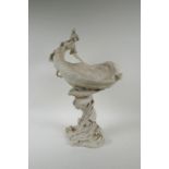 A Royal Dux porcelain Art Nouveau centrepiece depicting a nymph sitting on a leaf shaped bowl, the