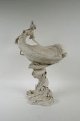 A Royal Dux porcelain Art Nouveau centrepiece depicting a nymph sitting on a leaf shaped bowl, the