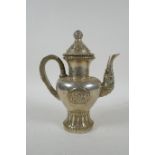 A Tibetan silvered metal coffee /tea pot, double vajra mark to base, 20cm high