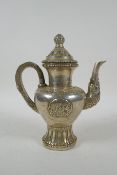 A Tibetan silvered metal coffee /tea pot, double vajra mark to base, 20cm high