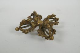 A Tibetan gilt metal double vajra, 15 x 15cm