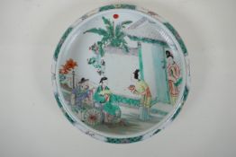 A famille vert porcelain dish with a rolled rim, decorated with figures in a garden, Chinese