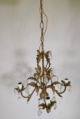 A French gilt metal four branch chandelier with lustre drops, 46cm wide, 80cm drop