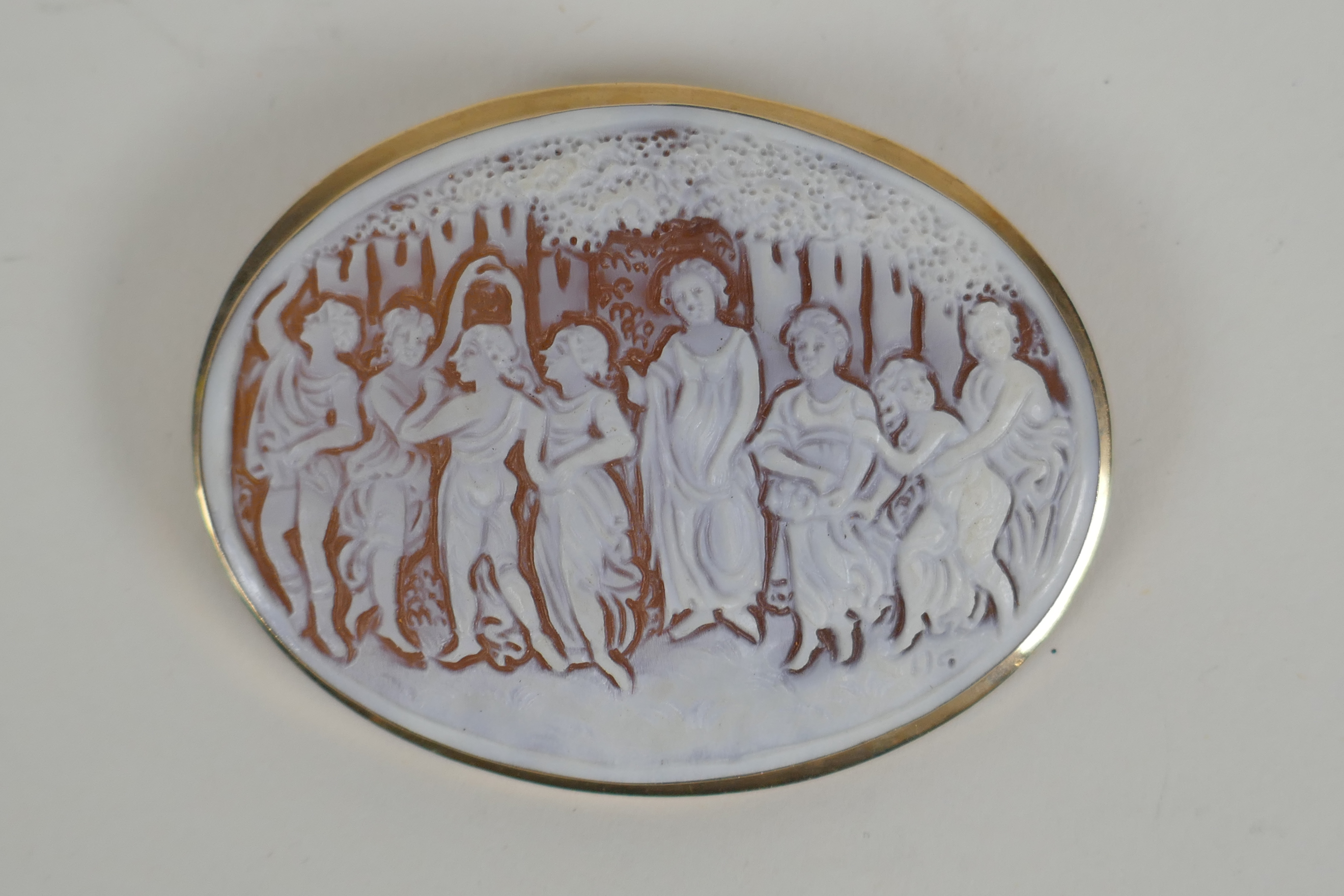 An antique cameo brooch depicting eight classical women in a 9ct yellow gold mount, 6.5 x 5cm