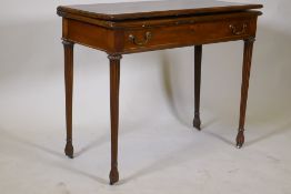 A Georgian mahogany fold over tea table, with single drawer and swan neck handles, raised on