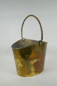An antique brass ice bucket with a braided handle, 30 x 21cm