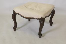 An early C19th rosewood footstool, raised on carved cabriole supports