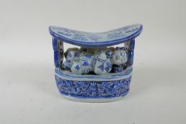 An early C20th Chinese blue and white porcelain pillow with figural and dragon decoration, 17 x 10 x