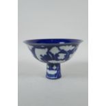 A Chinese sacrificial blue glazed porcelain stem bowl decorated with carp in a lotus pond, Xuande