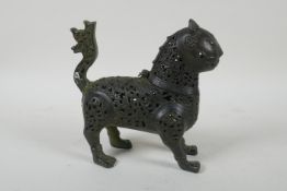 A Persian pierced bronze lion censer and cover, 18cm high