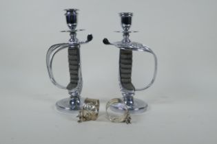A pair of chromed Victorian sword hilt candlesticks with shagreen handles, and a pair of silver