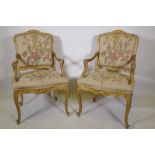 A pair of late C19th carved giltwood elbow chairs, labelled Bertram & Son, 100 and 101, Dean Street,