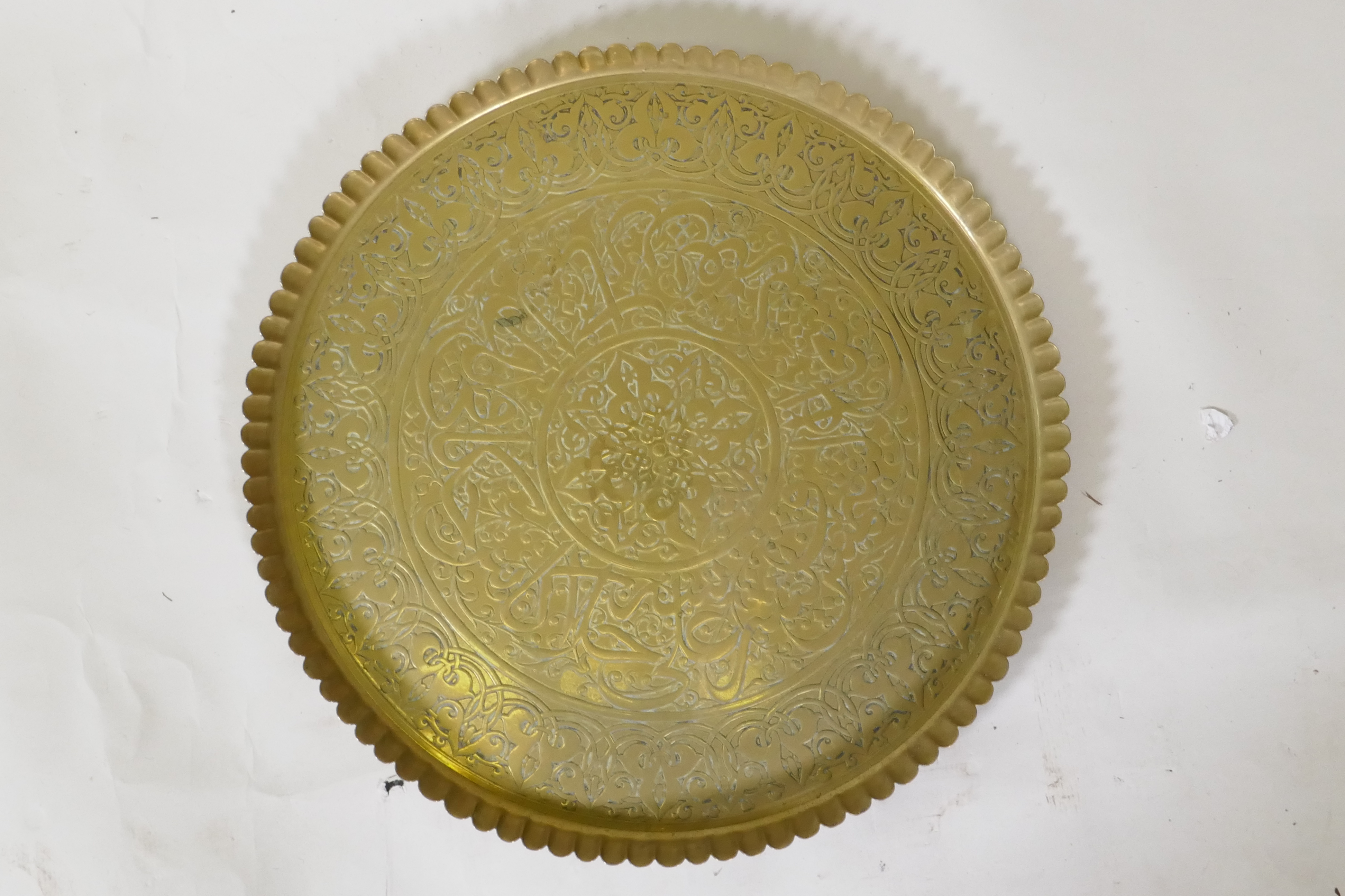 An Islamic brass tray with script decoration, together with another larger decorated with Islamic - Image 2 of 9