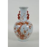 A Chinese two handled porcelain vase with iron red and gold decoration of birds amongst blossom,