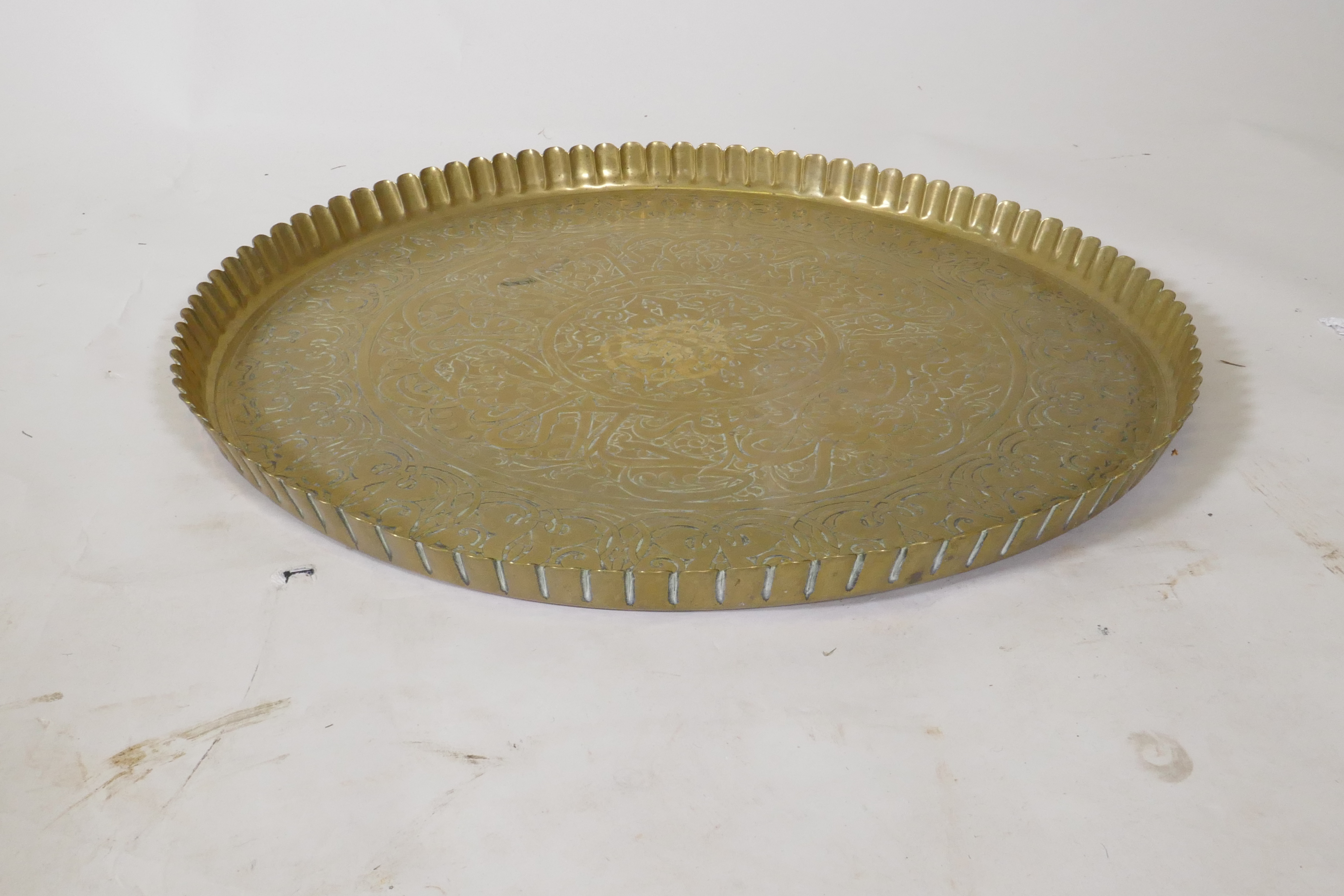 An Islamic brass tray with script decoration, together with another larger decorated with Islamic - Image 4 of 9