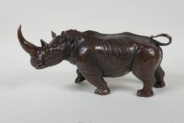 A filled bronze rhinoceros, 23cm long